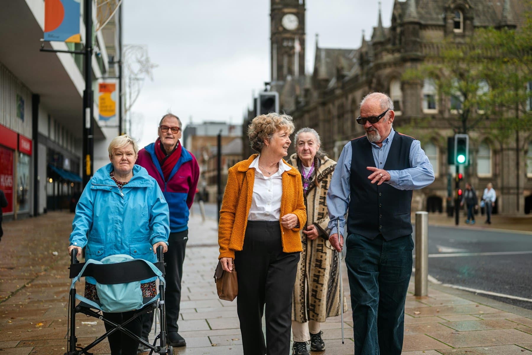 Older adults walking together on a city sidewalk, ordinary aging without clinic hype