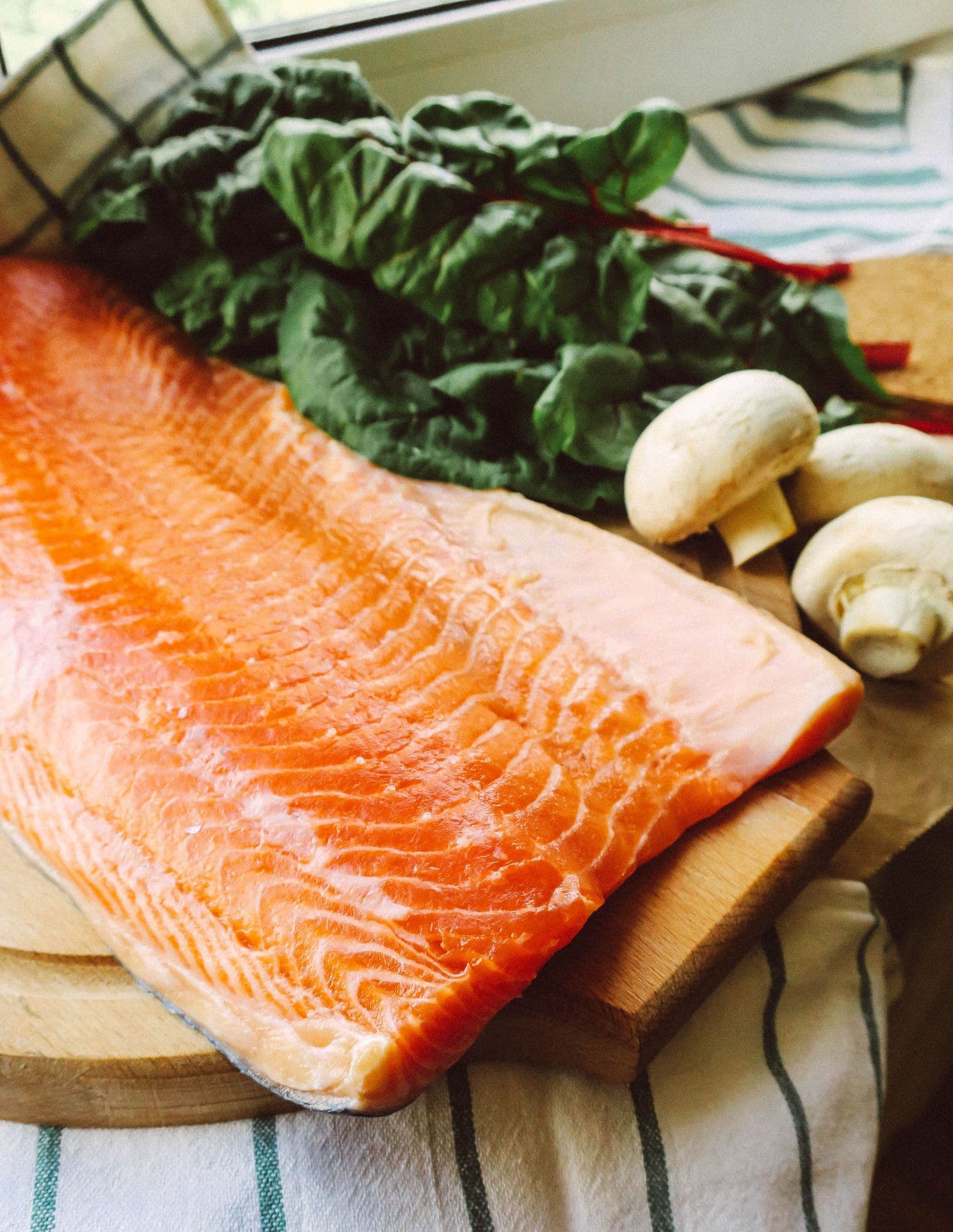 Raw salmon fillet on a cutting board, the food-first EPA and DHA source